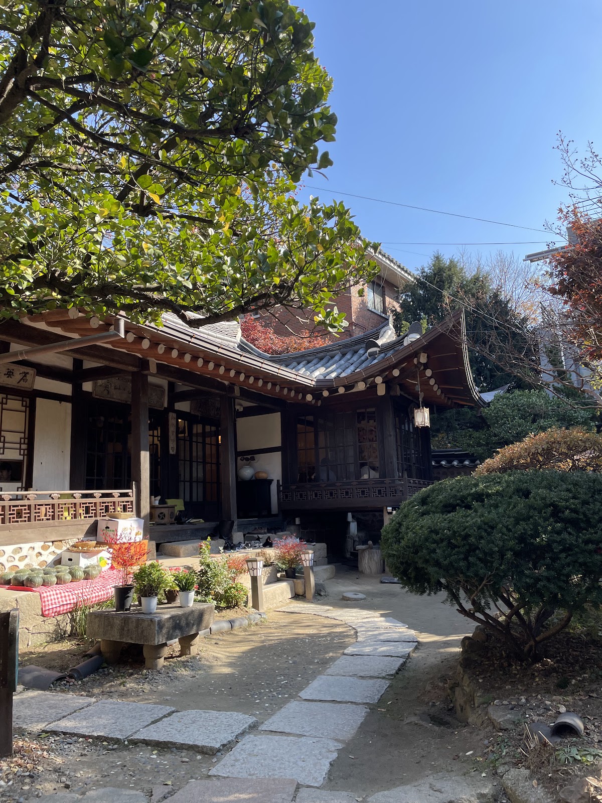 Suyeonsanbang hanok tea house with stone-paved path leading to the wooden gate and tile roof